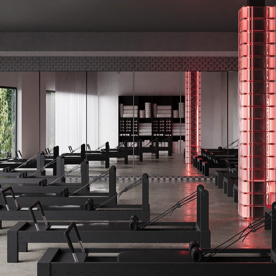 Le studio Reformer de Studio MA, colonnes de briques de verre éclairées en rouge.