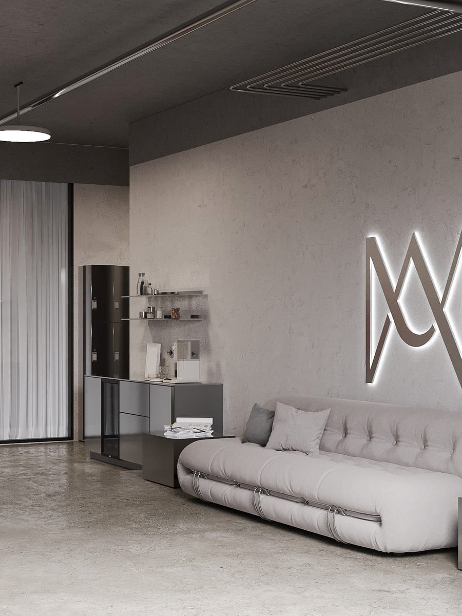 Le lounge de Studio MA, le coin café et le monogramme MA rétroéclairé.